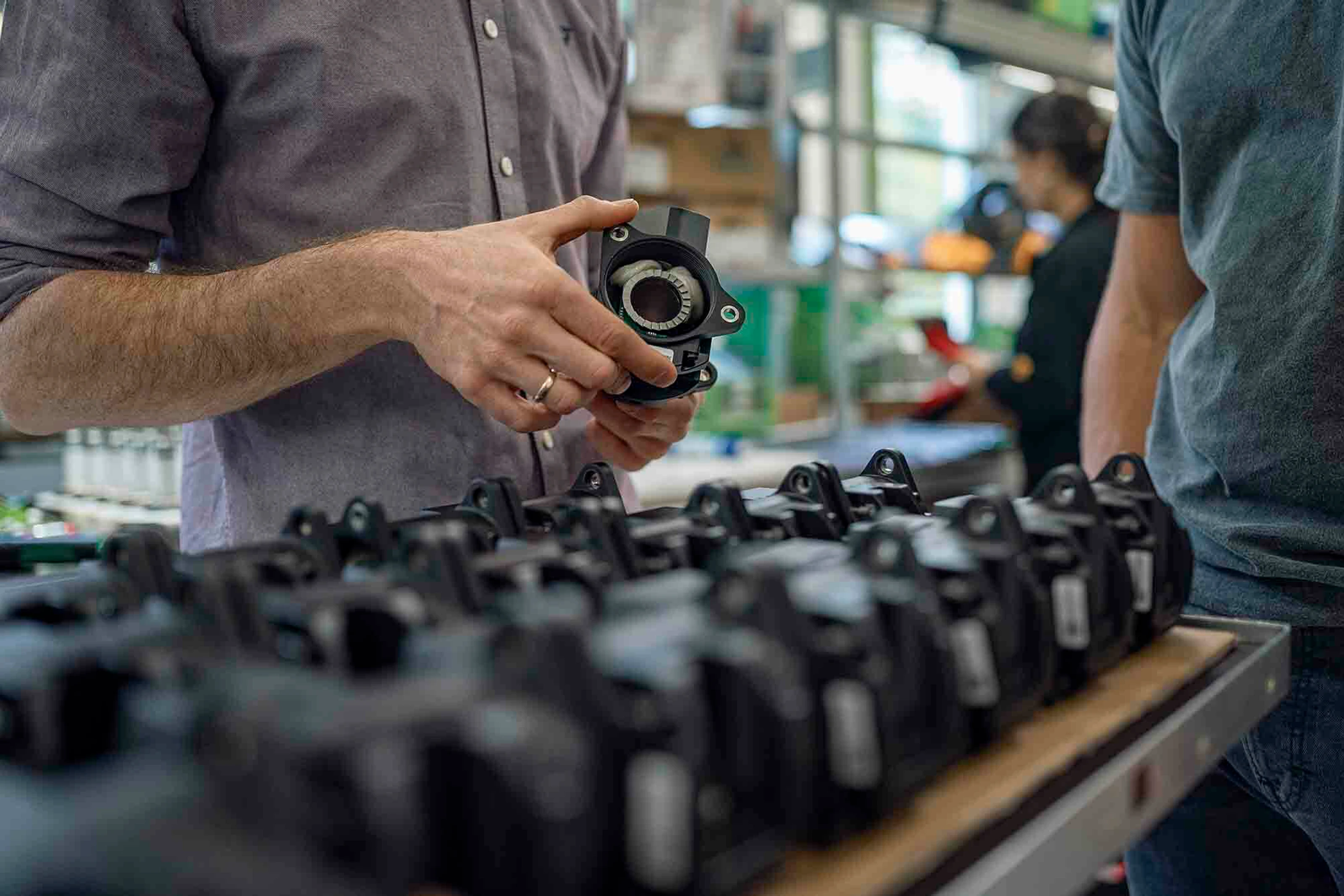 Two men looking at components of a bike