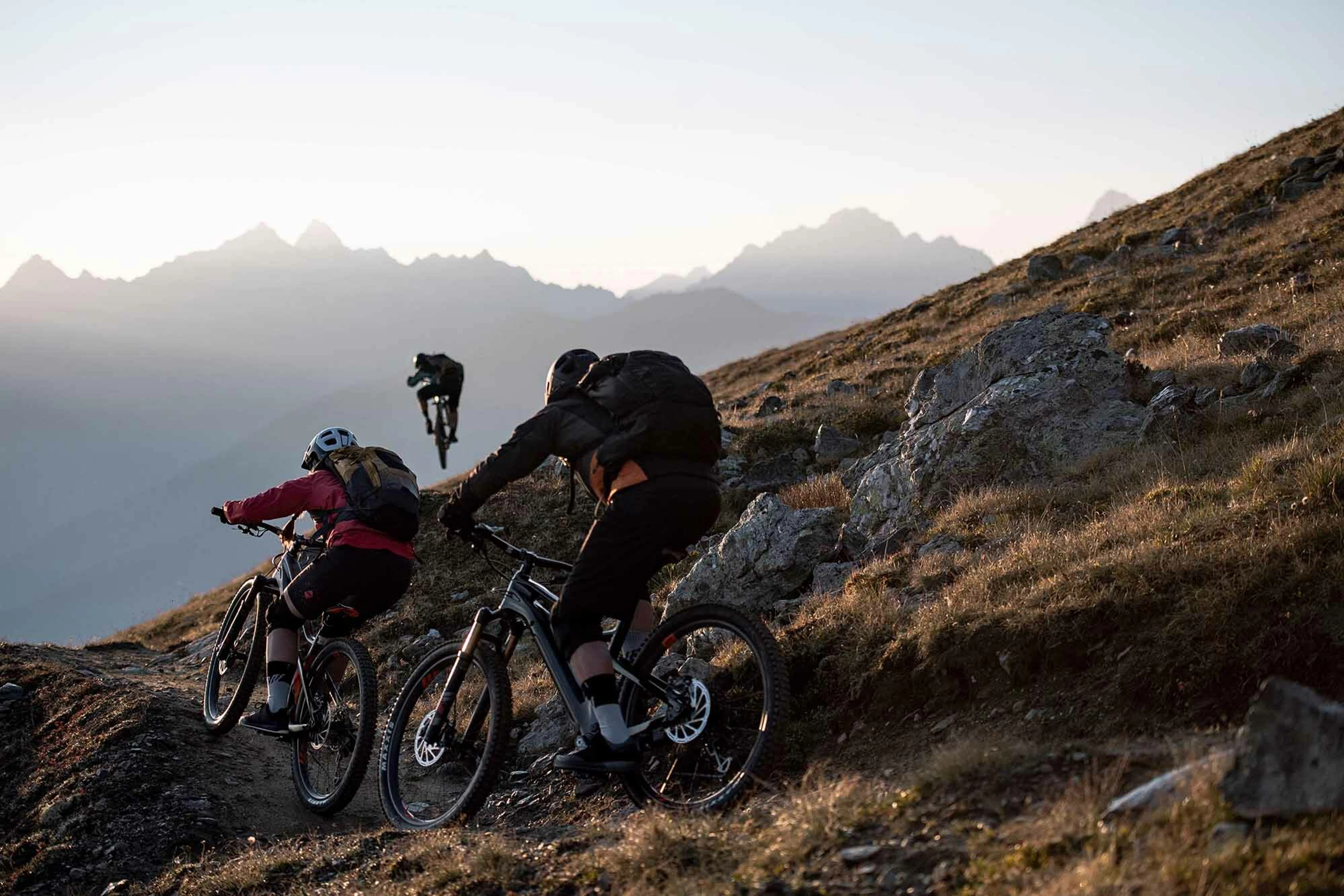 Mountainbikers cycling up on mountain terrain